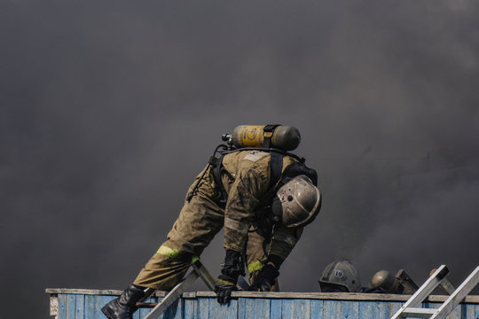 Firefighters Jump Over The Wall While Passing A Fire Strip