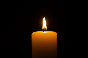 Close up of orange wax candle flame