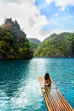 Woman sun bathing on the sea shore, Philippines