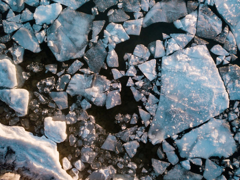 Lake ice breaking up makes abstract patterns on surface