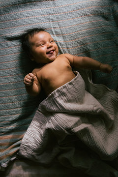 A Baby Lying in Beautiful Blankets