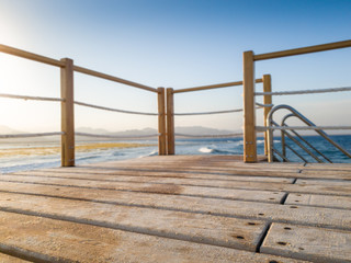 Closeup image of wooden board on the long pier in ocean. Perfect for inserting your image or...