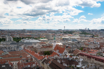 Wien, Austria. May, 2019. Panorama of the city from the observation tower of St. Stephen’s Cathedral. Roofs of houses. In the distance, the Alpine Mountains. Sky view.