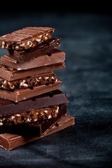 Chocolate bar pieces closeup. Sweet food photo concept.