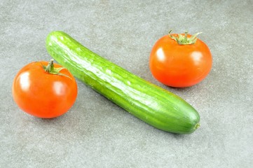 cucumber and tomatoes on a gray background