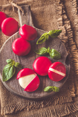 Small snack cheeses on the wooden board