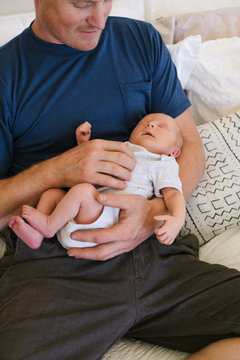 Man holding new baby inside.