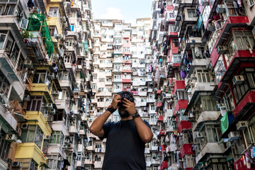 Photographer taking pictures of residencial buildings facades in Hong Kong