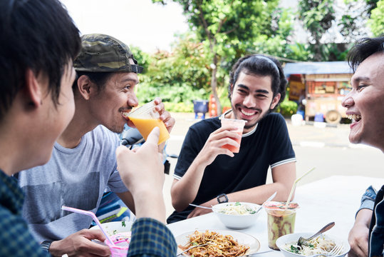 Best friends eating street food and healthy fresh juices in summer.