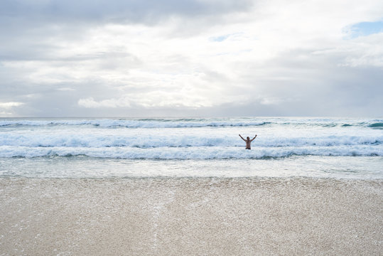 Aussie traveler go swimming to the beach in winter.