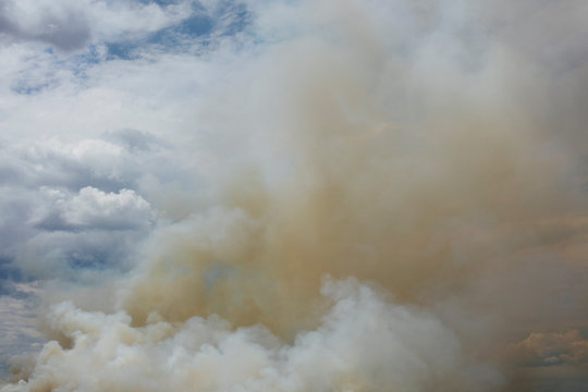Billowing smoke and clouds from controlled farmland burn, Saskatchewan, Canada
