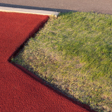 Close up of sports field, grass and painted asphalt