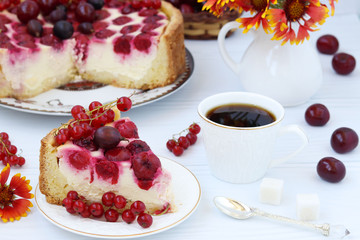 Cake with berries is located on a plate on a white background
