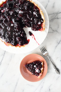 Cherry tart with a slice removed