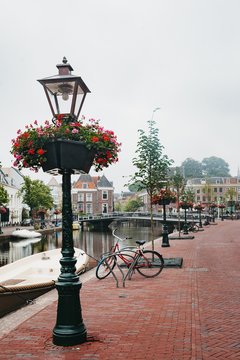 Lamp posts decorated with flowers along the canal in Holland