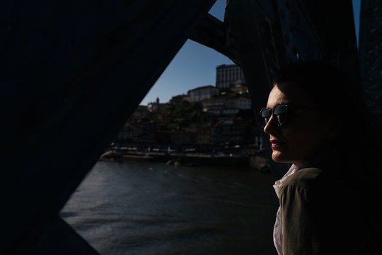 Woman in sunglasses standing on bridge