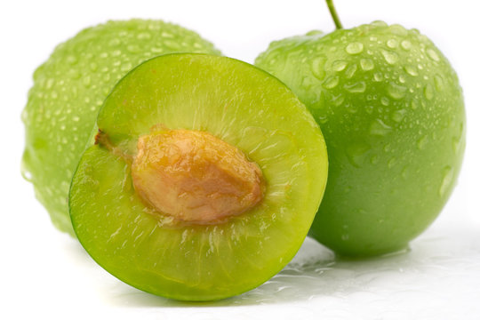 fresh and green plum on white background