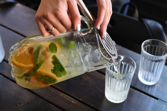 Woman pouring lemonade in a glass