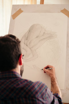 Artist drawing on a canvas at home