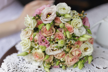 a bouquet of flowers and a white teapot on the table. Blurred background