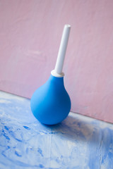 blue enema on a blue and pink background