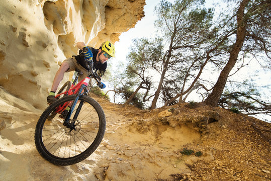 Cyclist descending through a very technical area of sandstone