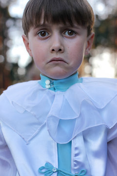 Sad boy in harlequin costume