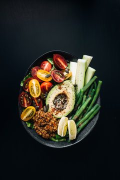 Lentils, avocado, cucumber, green beans and tomatoes bowl