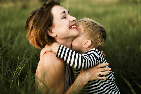 Mother hugs her little son outdoor