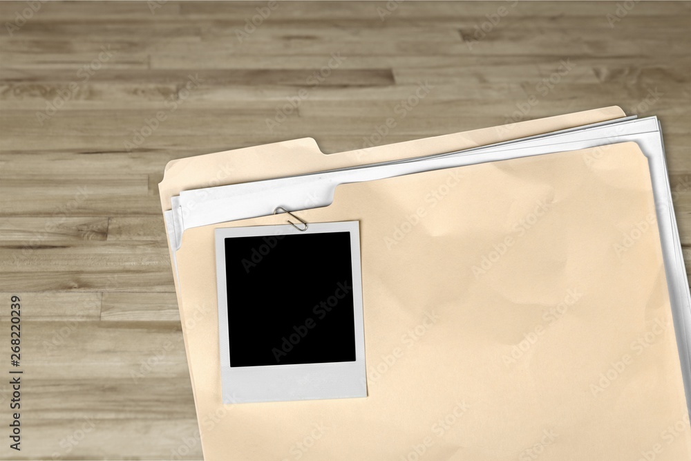 Poster file folder with documents and blank polaroid