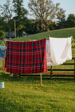 plaid sheets hang on clothesline