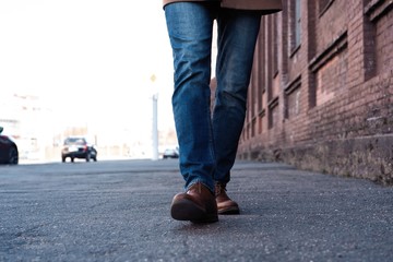 Male Legs In Jeans And Leather Boots Outdoor. Fashion Street Photo, color tone