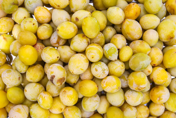 Fresh yellow plums. Ripe fruits in a wooden box in summer garden