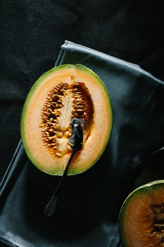 Overhead view of cantaloupe melon on napkin