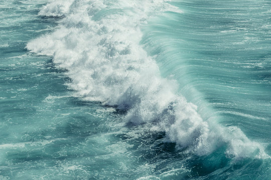 Breaking wave in turquoise ocean