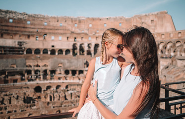 Young mother and little girl hugging in Coliseum, Rome, Italy.