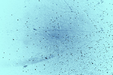 Vintage blue background. Rough painted wall of sapphire color. Imperfect plane of blue colored. Uneven old decorative toned backdrop of cyan tint. Texture of sapphirine hue. Ornamental stony surface.