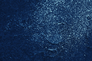 Vintage blue background. Rough painted wall of sapphire color. Imperfect plane of blue colored. Uneven old decorative toned backdrop of cyan tint. Texture of sapphirine hue. Ornamental stony surface.