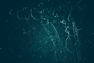 Vintage azure background. Rough painted wall of turquoise color. Imperfect plane of cyan colored. Uneven old decorative toned backdrop of aqzure tint. Texture of teal hue. Ornamental stony surface.
