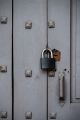 padlock on an old wooden door with wrought nails hats