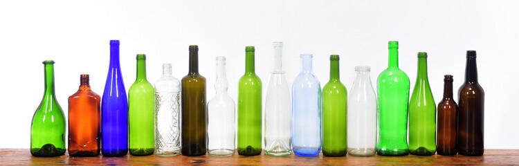 several bottles on top of a wooden table with a white background