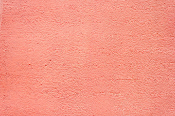 Background rough rustic shabby texture of old wall with pink orange salmon cracked plaster