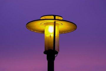 shining street lamp in the evening sky