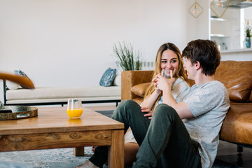 Happy couple sitting on the floor