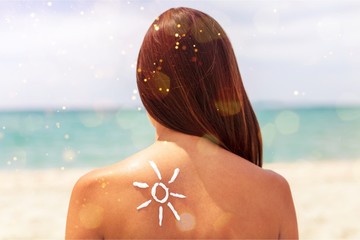 Beautiful Woman with Sunscreen Solar Cream over