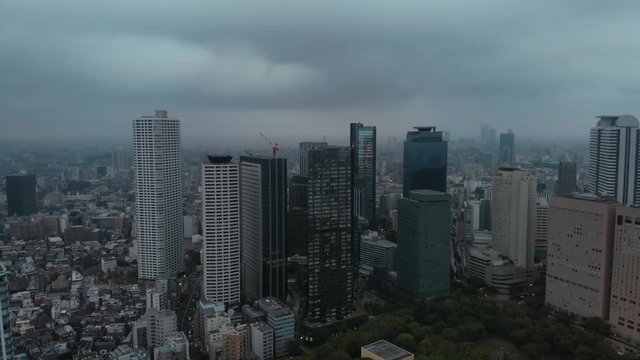 Tokyo, Shinjuku - diagonal descending aerial shot , Cloudy Morning, Japan