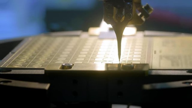 A special modern machine installs a silicon microprocessor on the board. The robot manipulator solders the chip contacts to the matrix. Modern computer technology