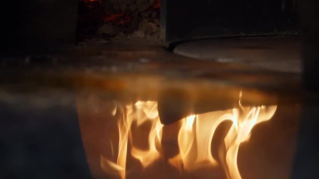 Close-up of fire wood burning in the reflection of the pizza oven. Frame. Italian pizzeria and Traditional Pizza oven