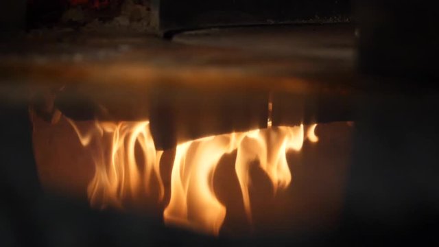 Close-up of fire wood burning in the reflection of the pizza oven. Frame. Italian pizzeria and Traditional Pizza oven