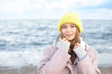 Portrait of beautiful young woman near sea